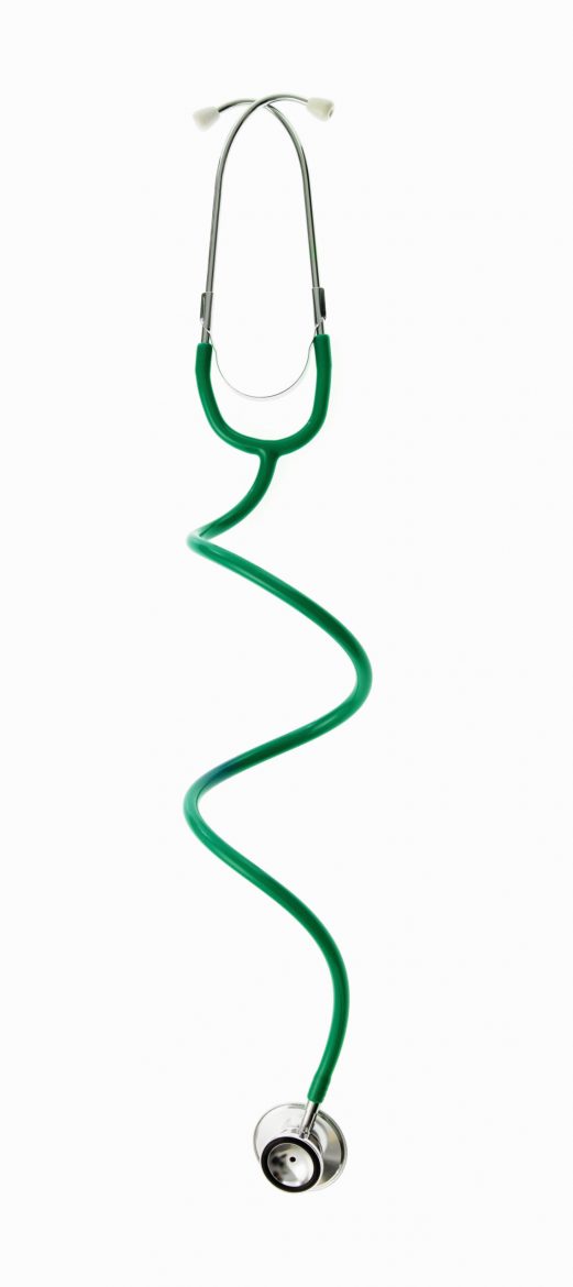 A doctor's stethoscope with green tubing, a conceptual illustration of alternative medicine and wellbeing.